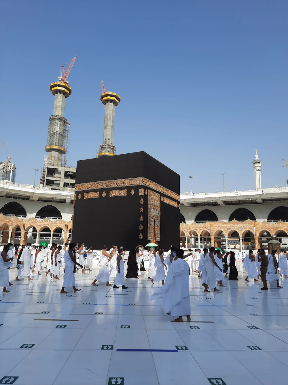 Pilgrims walking inside the courtyard of a mosque in Makkah